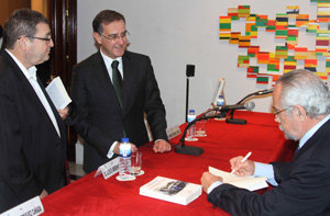 El autor firmando ejemplares para los diputados Collarte y Ruano