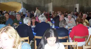 La lluvia provocó que la comida de hermandad tuviera que celebrarse en una nave agrícola.