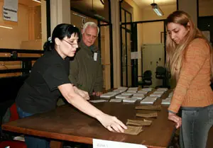 Una integrante de una mesa electoral coloca las papeletas de las candidaturas.