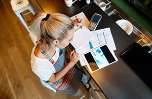 Portrait of a business manager doing the books at a bar using a tablet computer