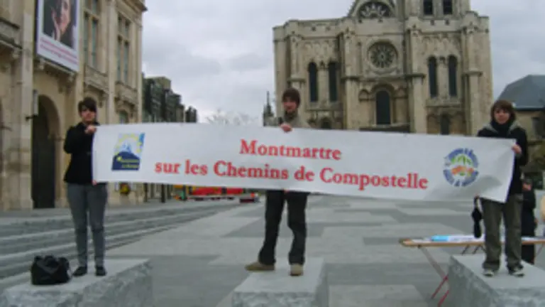  Participantes en la convocatoria sostienen un cartel publicitario del Camino.