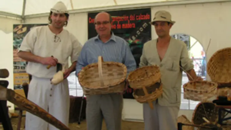 Rodr&iacute;guez junto a un \'zoqueiro\' y un \'cesteiro\', en el taller artesano.