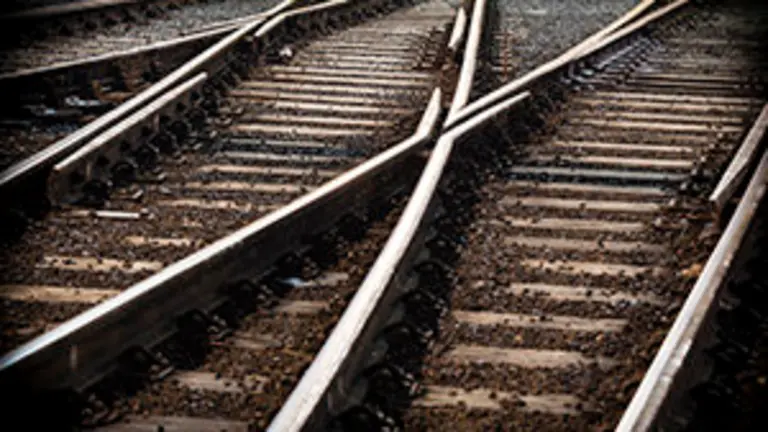train line crossing at night, with selective focus & vignetting.