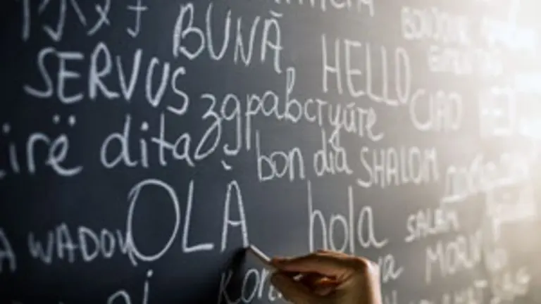 Hello in many languages written with chalk on blackboard